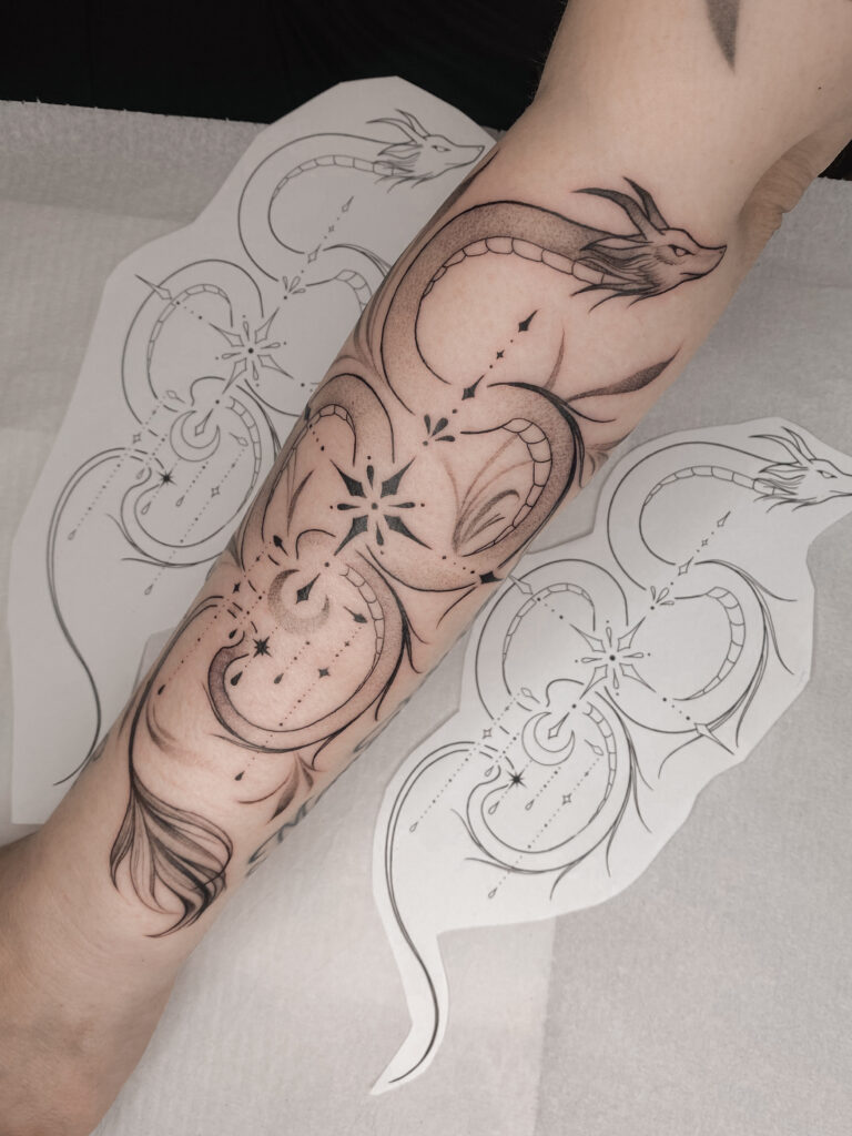 Fineline celestial dragon tattoo on forearm by Meow Ink Alex Lukasiewicz in Den Haag
