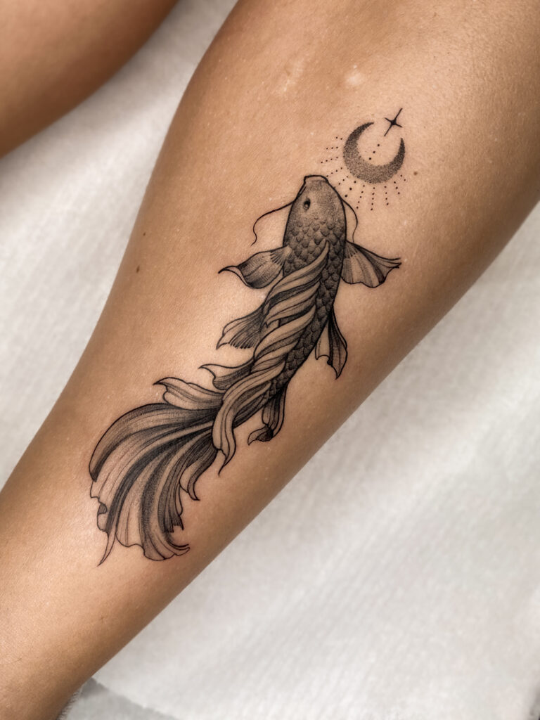 Fineline koi fish tattoo with subtle shading and additional dotwork crescent moon with sprakle, done by Alex Lukasiewicz Meow Ink in tattoo shop in Den Haag