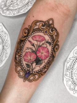 Elegant neotraditional cameo tattoo with morning glories by Meow Ink Alex Lukasiewicz Neotraditional cameo tattoo with pink morning glory flowers and golden frame by Meow Ink Alex Lukasiewicz